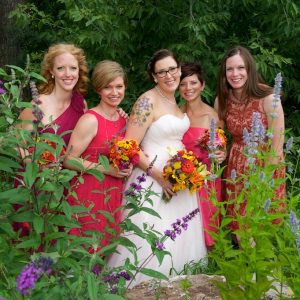 Bridal party posing with bride at Lyons Farmette wedding in Lyons, CO